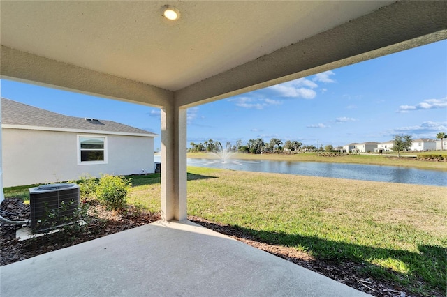 view of patio / terrace with a water view and central AC unit