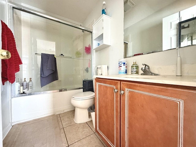 full bathroom featuring enclosed tub / shower combo, tile patterned floors, toilet, and vanity