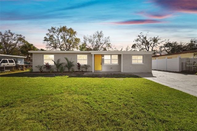 ranch-style home with a yard