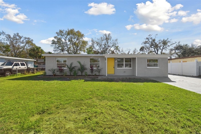 ranch-style home featuring a front yard