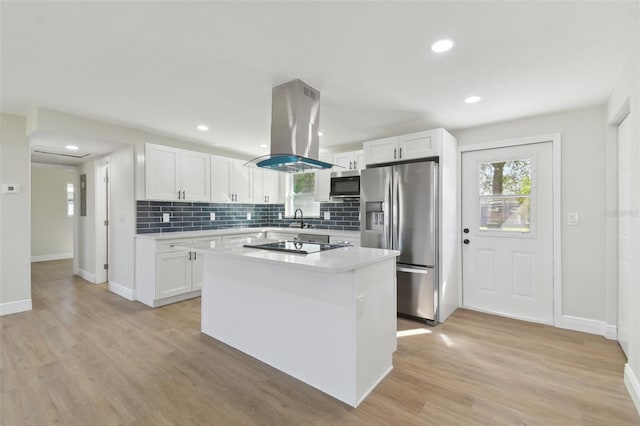 kitchen with white cabinetry, island range hood, stainless steel appliances, and a center island