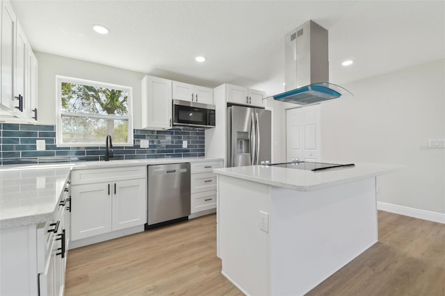 kitchen featuring a kitchen island, island range hood, sink, white cabinets, and stainless steel appliances