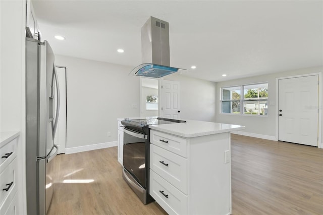 kitchen featuring stainless steel appliances, island exhaust hood, white cabinets, and light hardwood / wood-style flooring