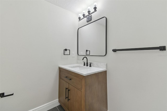 bathroom with vanity and a textured ceiling