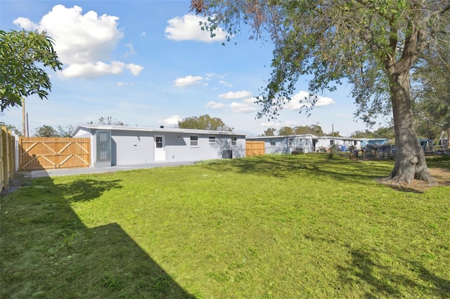 rear view of property with a yard