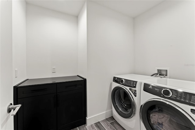 5120 Marina Way Unit 14002, Tampa, FL 33611 - washroom featuring cabinet space, baseboards, washer and dryer, and wood finish floors