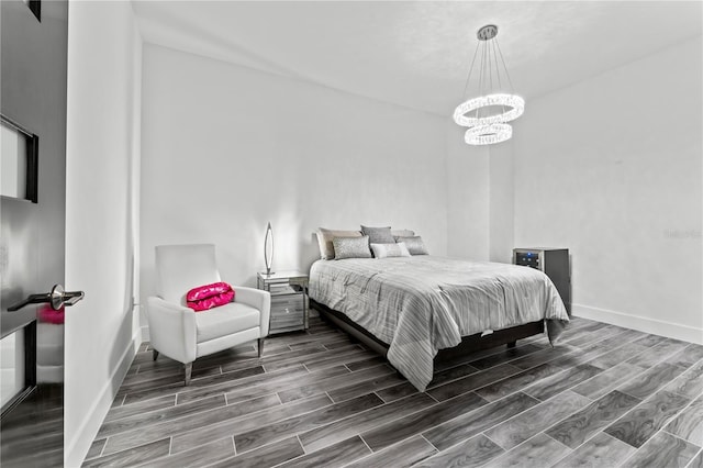 5120 Marina Way Unit 14002, Tampa, FL 33611 - bedroom featuring a chandelier, wood finish floors, and baseboards