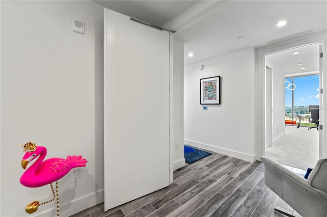 corridor with wood finish floors, floor to ceiling windows, recessed lighting, visible vents, and baseboards