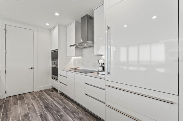 5120 Marina Way Unit 14002, Tampa, FL 33611 - kitchen with wall chimney range hood, modern cabinets, stainless steel oven, and white cabinetry