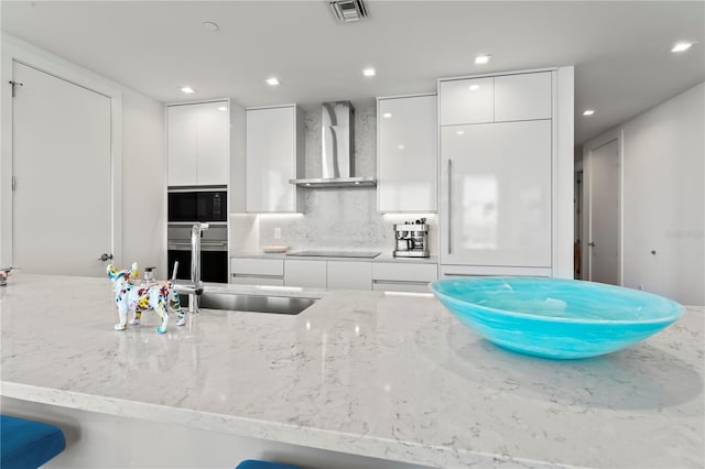 5120 Marina Way Unit 14002, Tampa, FL 33611 - kitchen featuring wall chimney range hood, modern cabinets, visible vents, and white cabinets