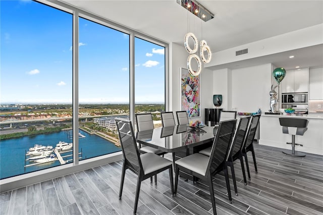 5120 Marina Way Unit 14002, Tampa, FL 33611 - dining room with a wall of windows, wood finish floors, visible vents, and a water view
