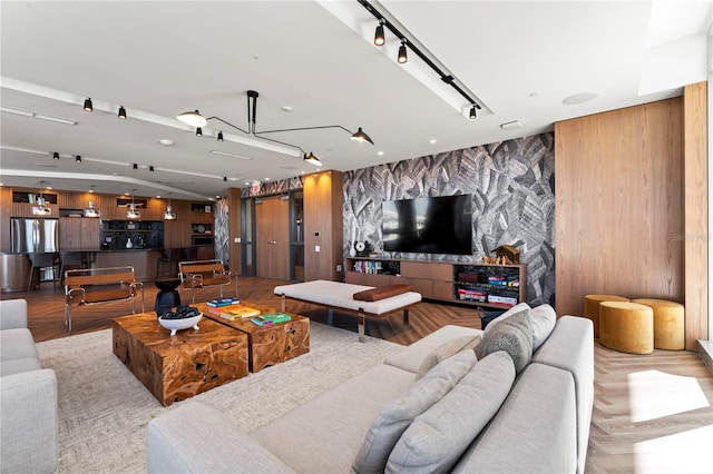 5120 Marina Way Unit 14002, Tampa, FL 33611 - living area featuring an accent wall, wood finished floors, rail lighting, and wallpapered walls