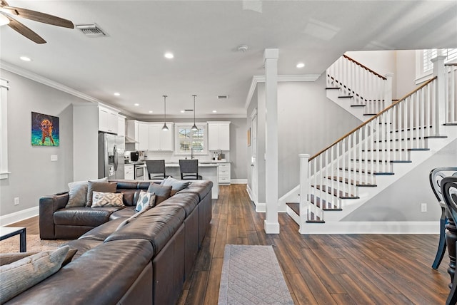 living room with ceiling fan, ornamental molding, and dark hardwood / wood-style flooring