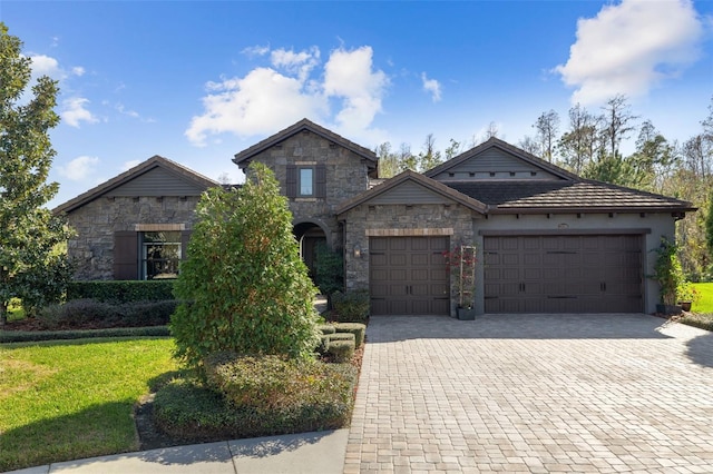 view of front facade featuring a garage and a front lawn