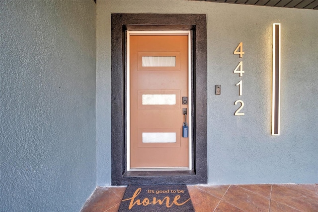 doorway to property with stucco siding