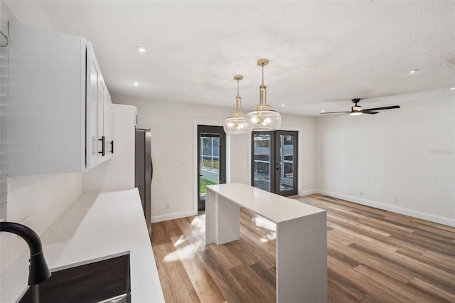 dining area featuring a ceiling fan, baseboards, light wood finished floors, recessed lighting, and french doors