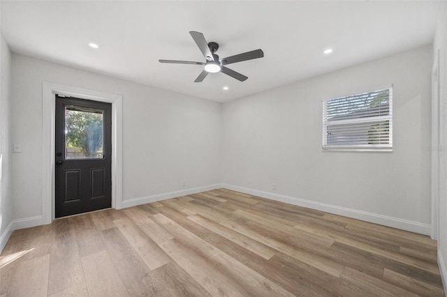 spare room with recessed lighting, light wood-type flooring, and baseboards