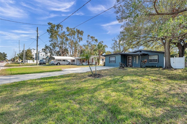 view of yard featuring fence and driveway