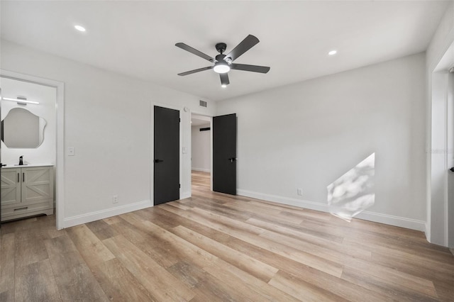 unfurnished bedroom featuring light wood finished floors, recessed lighting, and baseboards