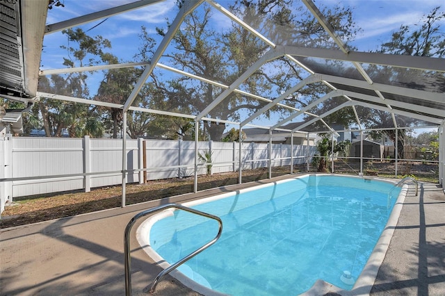 view of swimming pool featuring a lanai, a fenced backyard, and a fenced in pool