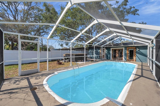 view of pool with a lanai, a fenced in pool, a fenced backyard, and a patio area