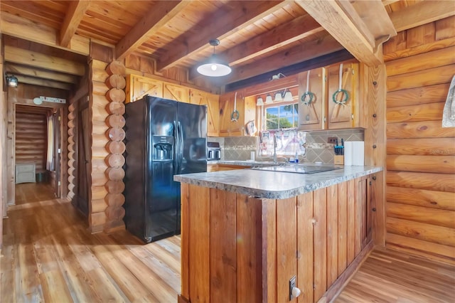 kitchen featuring light hardwood / wood-style flooring, kitchen peninsula, backsplash, and black appliances