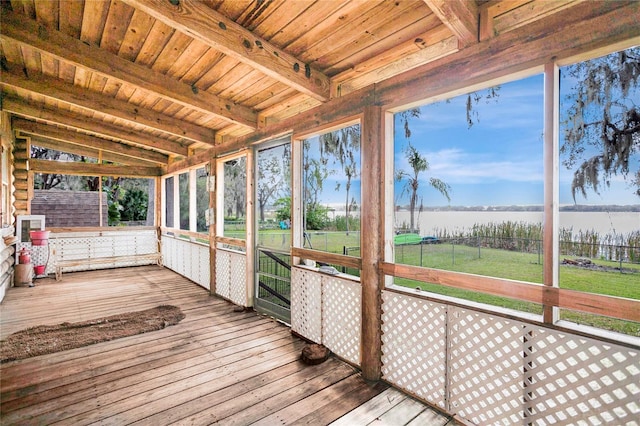 unfurnished sunroom with a water view, vaulted ceiling with beams, and wood ceiling