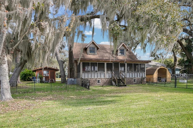 back of property with a sunroom and a lawn