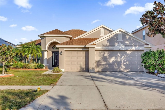 view of front of house with a garage and a front yard