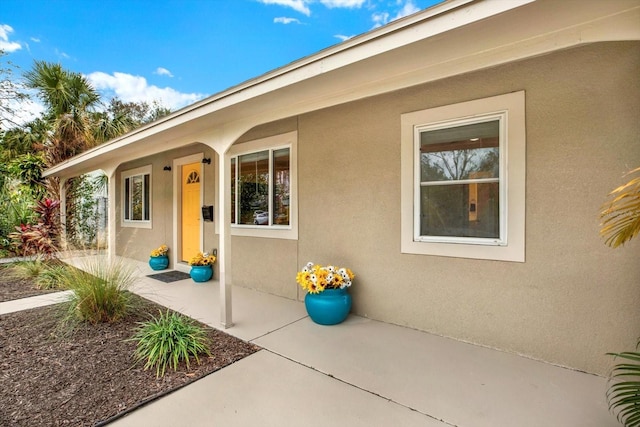 property entrance featuring a patio