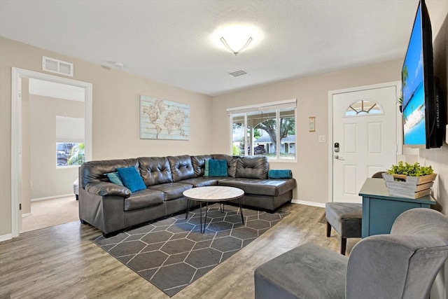 living room with plenty of natural light and dark hardwood / wood-style floors