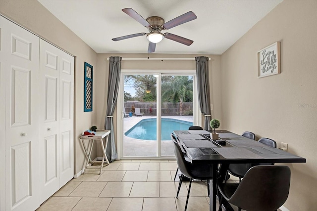 tiled dining space with ceiling fan