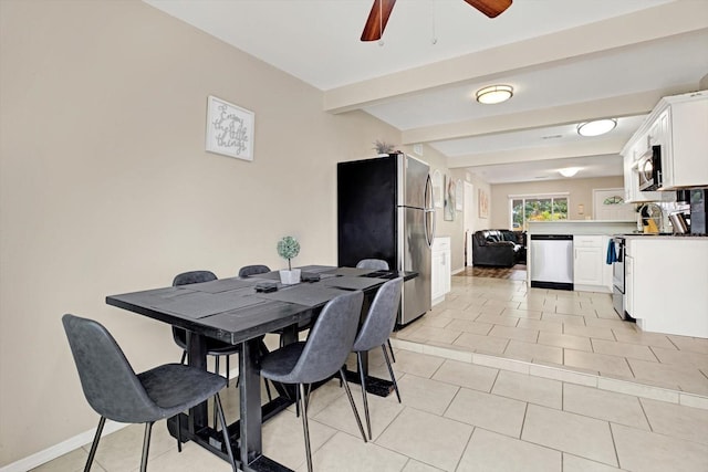 tiled dining space with ceiling fan and beam ceiling