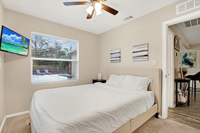 bedroom with ceiling fan and light colored carpet