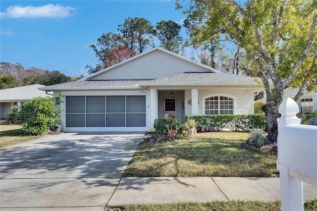 view of front of house with a garage and a front yard