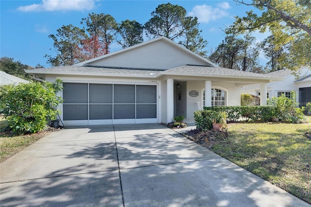 view of front of property with a garage and a front yard