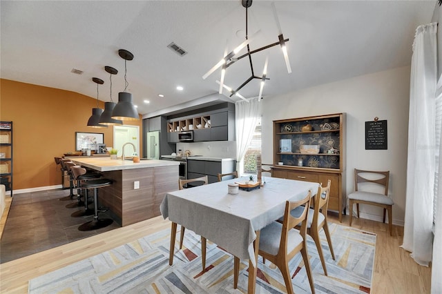 dining room with sink and light hardwood / wood-style floors