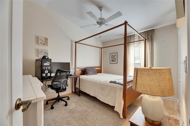 bedroom with lofted ceiling, ceiling fan, and light hardwood / wood-style flooring