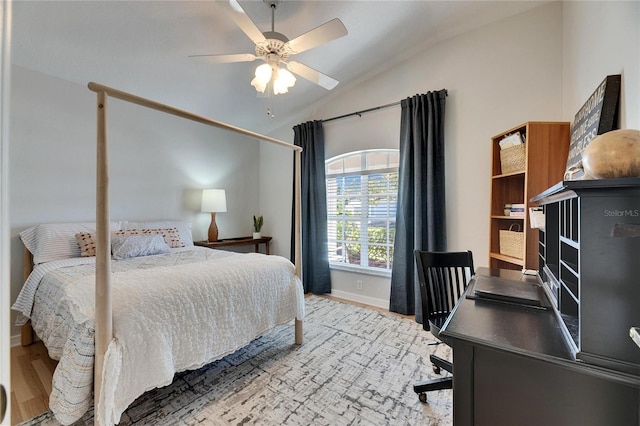 bedroom with vaulted ceiling, wood-type flooring, and ceiling fan