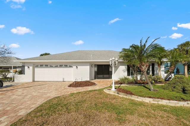 ranch-style house featuring a garage and a front yard