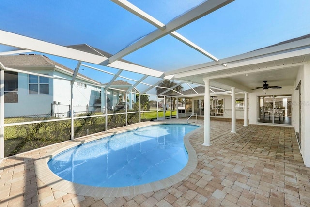 view of pool featuring a patio, ceiling fan, and glass enclosure