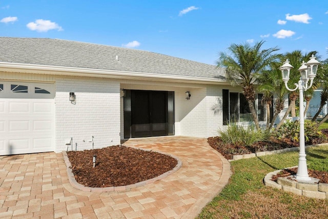 view of exterior entry featuring a garage