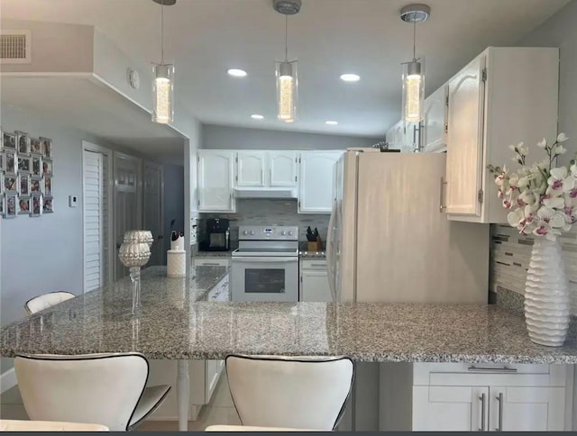 kitchen featuring white appliances, decorative backsplash, and white cabinets