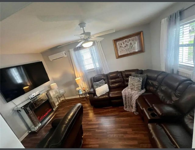 living room with a wall unit AC, dark hardwood / wood-style floors, and ceiling fan