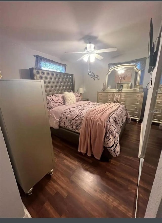 bedroom with ceiling fan and dark hardwood / wood-style flooring