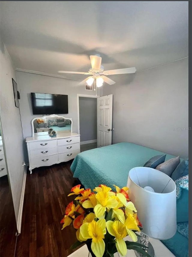 bedroom with ceiling fan and dark hardwood / wood-style flooring