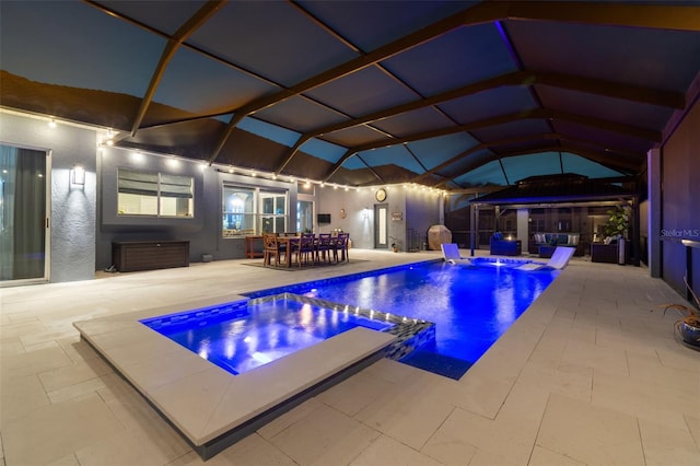 view of swimming pool featuring an in ground hot tub, glass enclosure, and a patio area