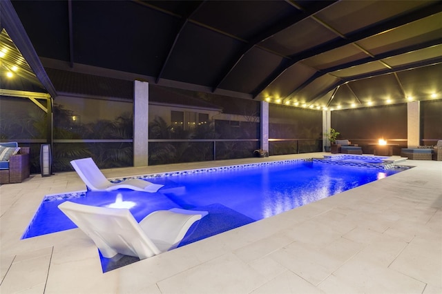 view of pool with a patio area, a hot tub, and glass enclosure