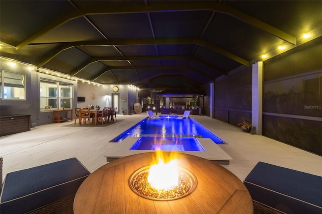 view of pool with a fire pit and a patio area