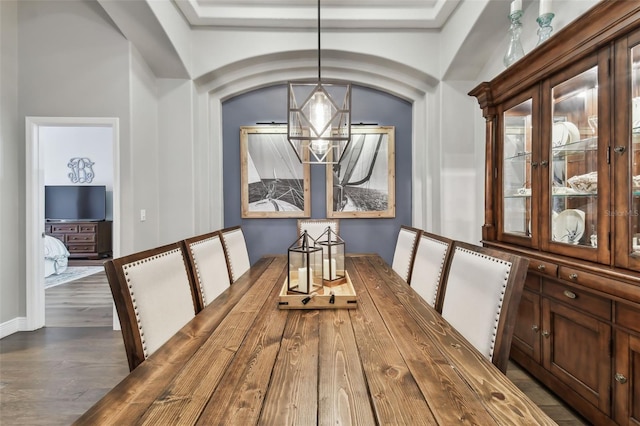 dining area featuring hardwood / wood-style floors and a notable chandelier